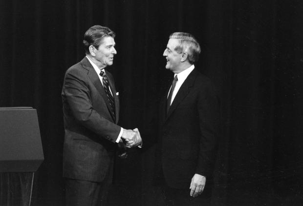 President Ronald Reagan and his Democratic challenger Walter Mondale, shake hands before debating.