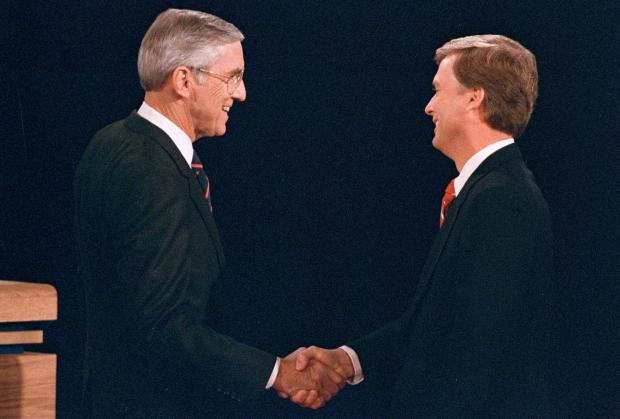 Sen. Lloyd Bentsen, D-Texas, shakes hands with Sen. Dan Quayle, R-Ind., before the start of their vice presidential debate.