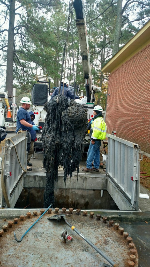 Flushable wipes being lifted from container at Hampton Roads Sanitation District Virginia Initiative Wastewater Treatment Plant in Norfolk, (askHRgreen.org)