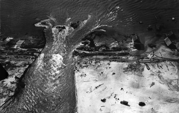 The inlet cut through Ocean City's barrier beach, from the Atlantic to Sinepuxent Bay, by the great hurricane of August 1933. This photo was made shortly after the storm. Sun Staff File Photo 8/17/33