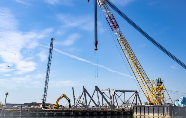 A 400-ton section of the Francis Scott Key Bridge is seen adjacent to the Chesapeake 1000 crane Monday. The piece, the largest so far, was moved from the collapse site to a lot at Tradepoint Atlantic over the weekend. (Jerry Jackson/Staff)