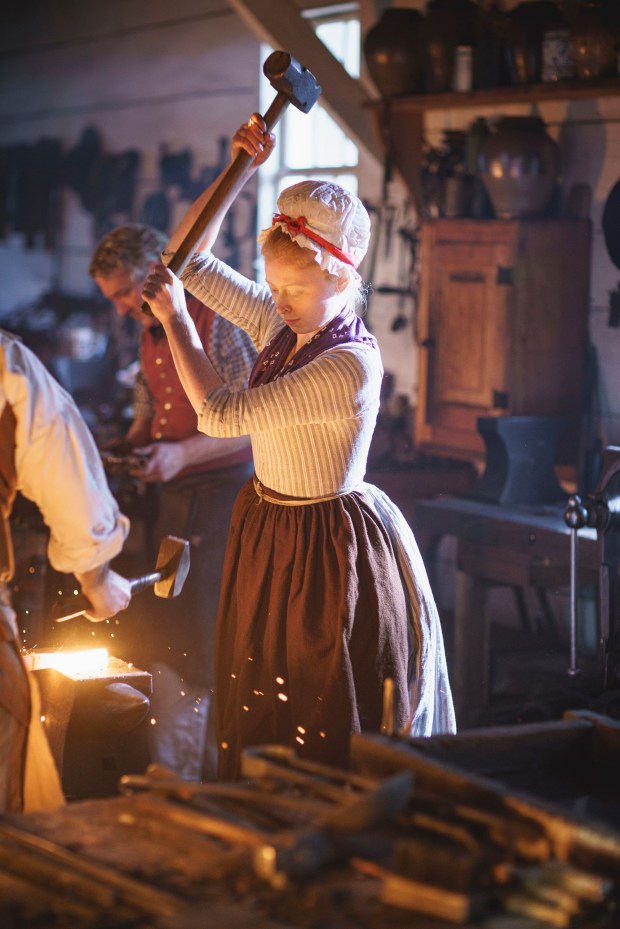 Blacksmith Aislinn Lewis works at a forge.