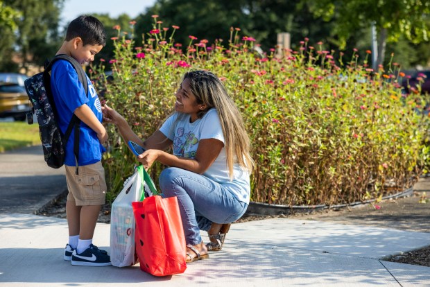 Andrea Vilcherrez encourages a laugh out of her nervous son Kevin Pineda before he heads into his first day of first grade at Green Run Elementary in Virginia Beach on Monday, Aug. 26, 2024. (Kendall Warner / The Virginian-Pilot)