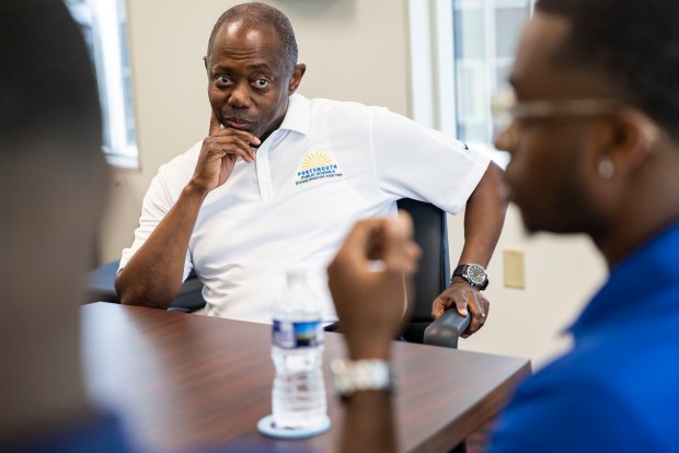 Superintendent Elie Bracy III listens to his sons speak about why they decided to become educators during an interview in Bracy's office at Portsmouth City Hall on Wednesday, Aug. 14, 2024. (Kendall Warner / The Virginian-Pilot)