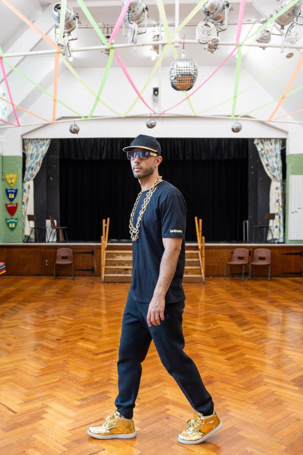 Jacob Mitchell at Foulds School, his alma mater, in High Barnet, England, on June 24, 2024. Under the name of his alter ego, MC Grammar, Mitchell has become a wildly popular performer whose rhymes have made reading and grammar all the rage among young people across Britain. (Jeremie Souteyrat/The New York Times)