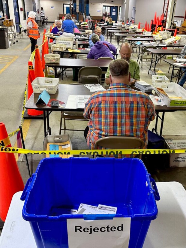 Poll workers process absentee ballots in Milwaukee